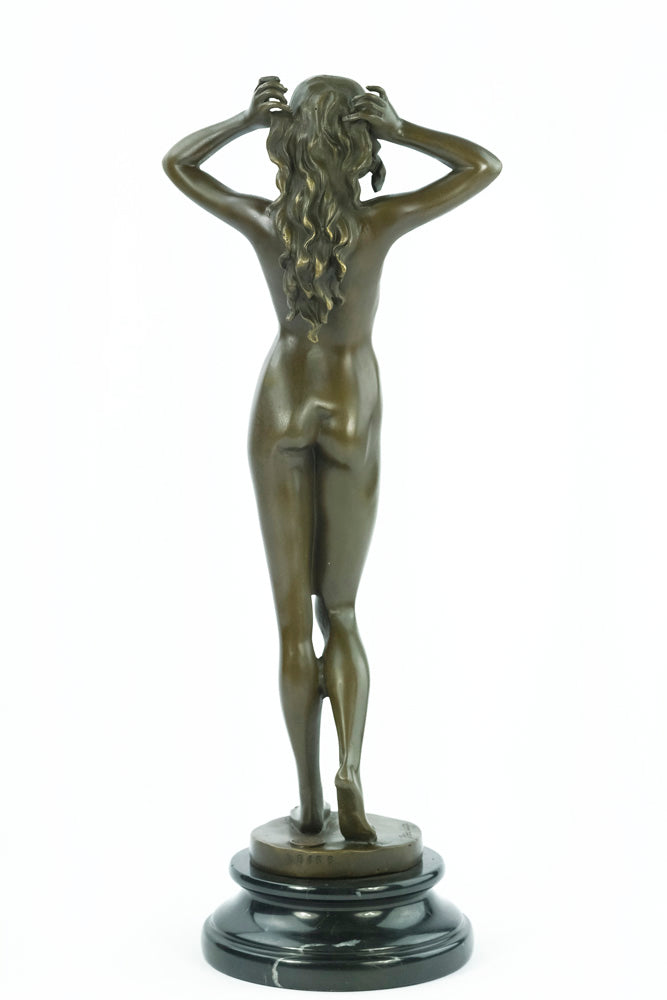 Bronze sculpture of a female nude playing with her hair