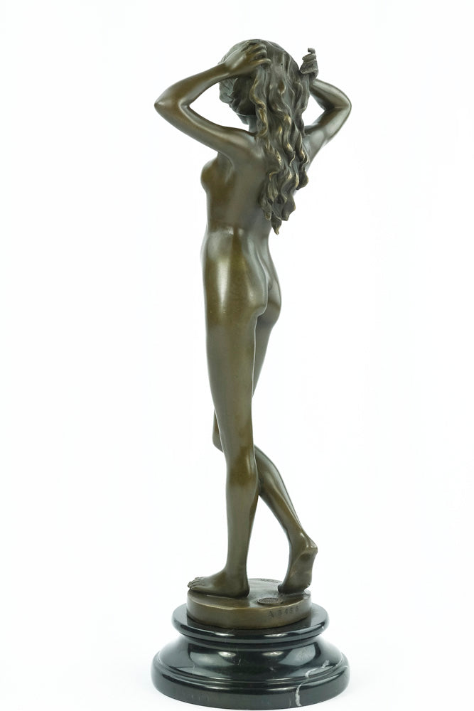 Bronze sculpture of a female nude playing with her hair