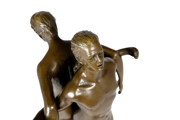 Bronze sculpture of a male couple standing back to back