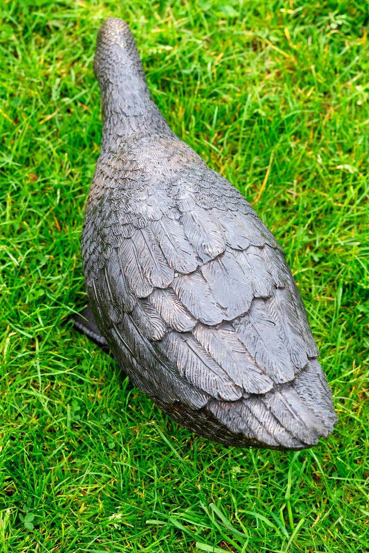 Large bronze sculpture of a foraging duck