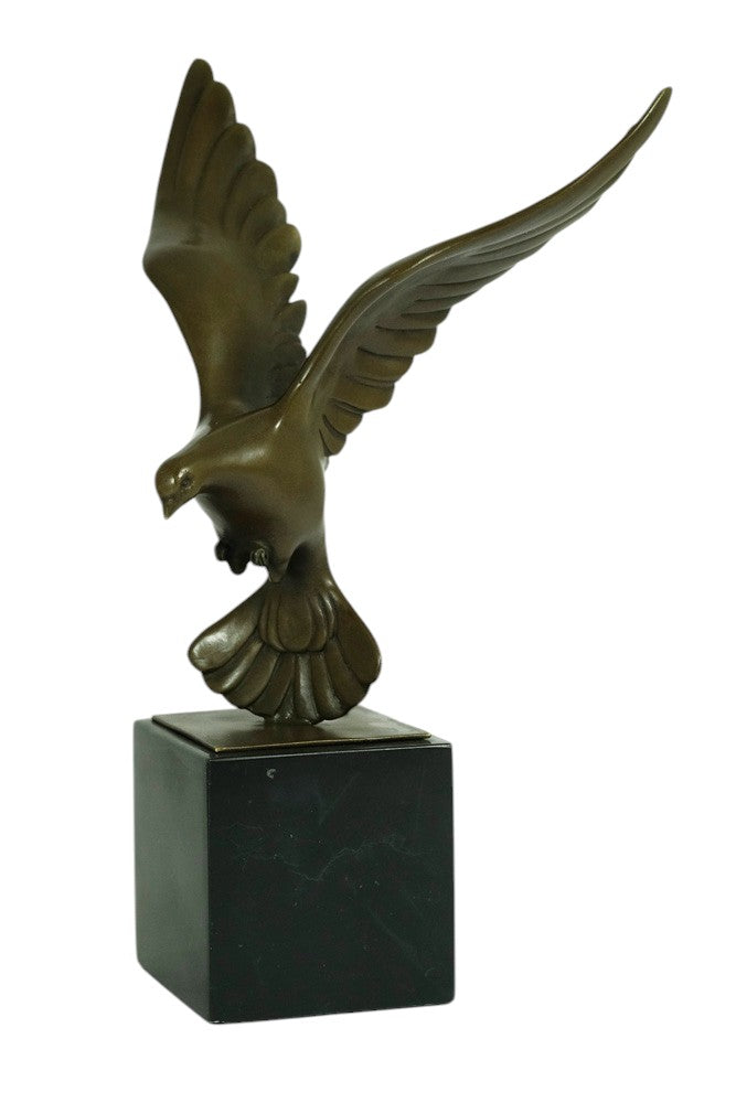 Bronze sculpture of a pigeon descending with wings spread