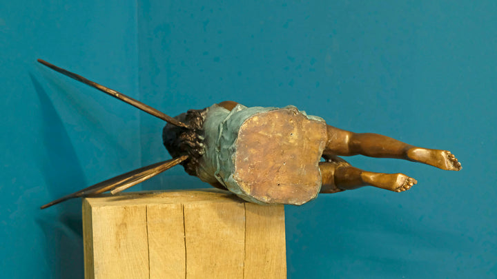 Bronze sculpture of a sitting winged fairy