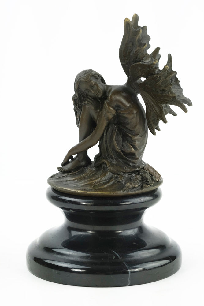 Bronze sculpture of a resting winged fairy