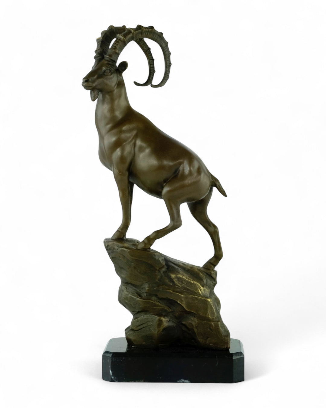 Bronze sculpture of an ibex on a rock