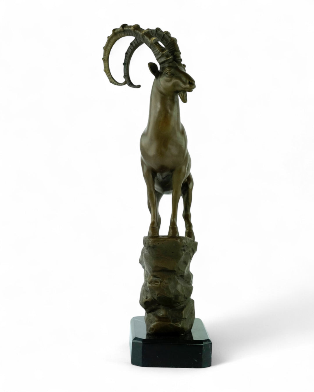 Bronze sculpture of an ibex on a rock
