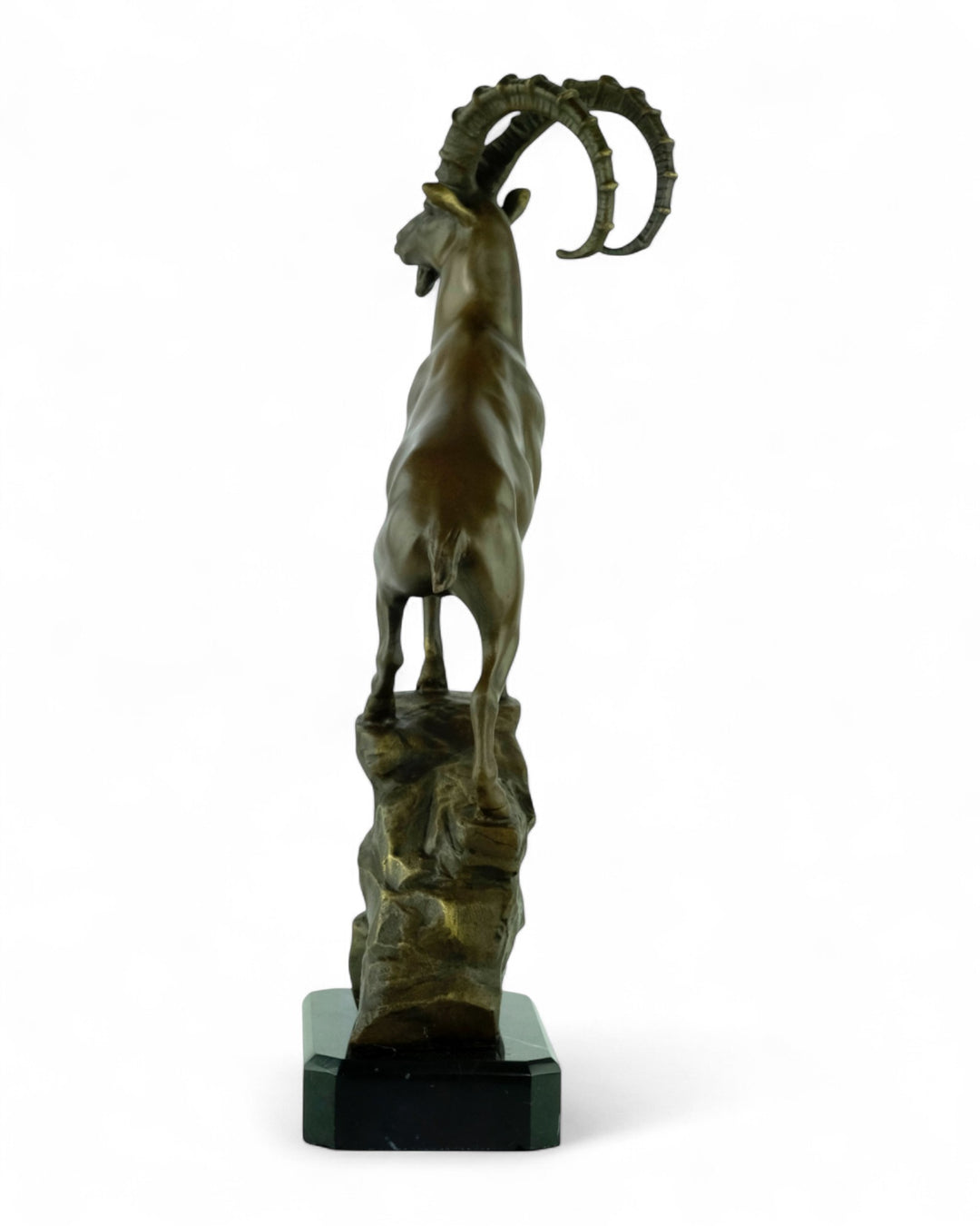 Bronze sculpture of an ibex on a rock