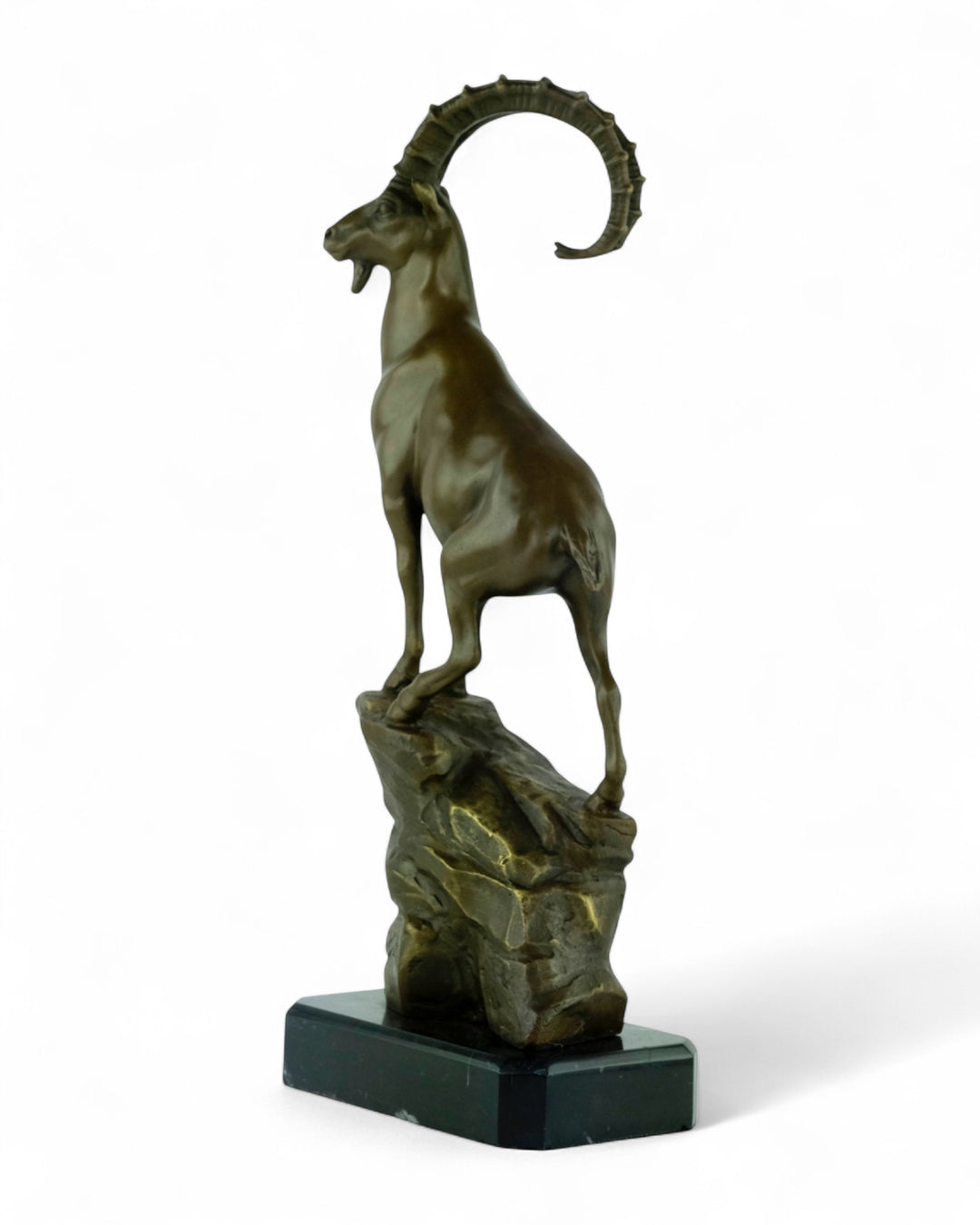 Bronze sculpture of an ibex on a rock