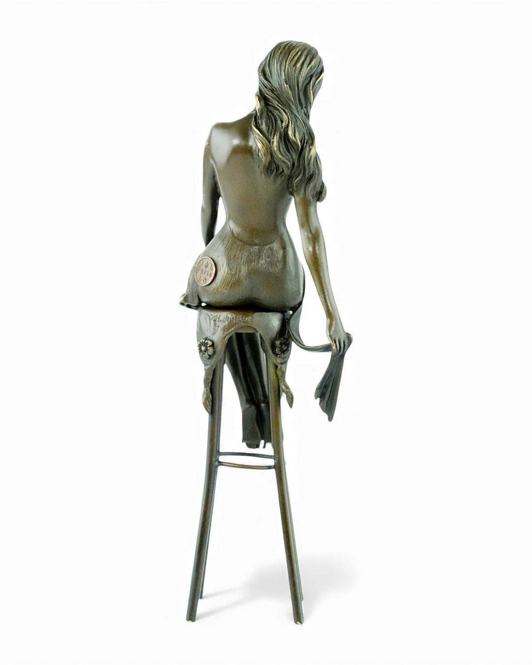 Bronze sculpture of a female on a barstool wearing a sensual dress
