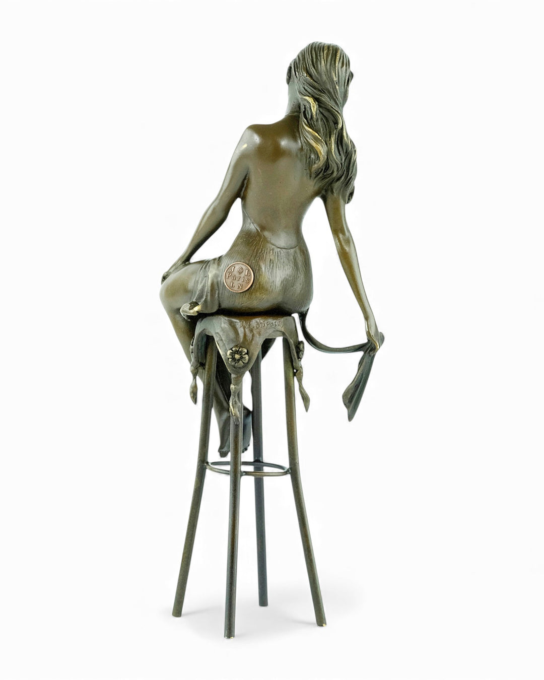 Bronze sculpture of a female on a barstool wearing a sensual dress
