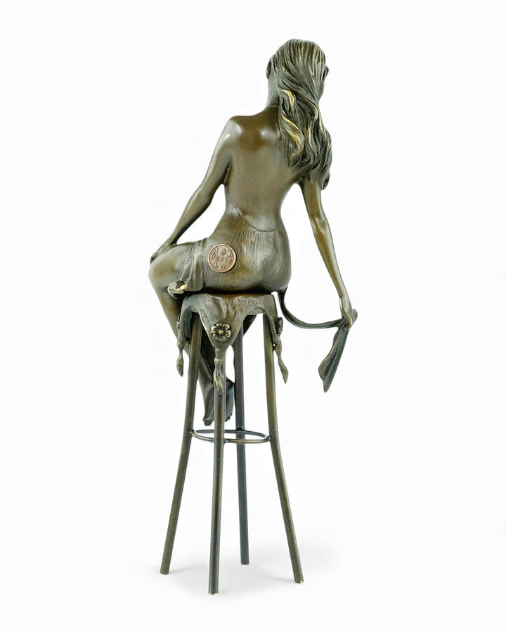 Bronze sculpture of a female on a barstool wearing a sensual dress