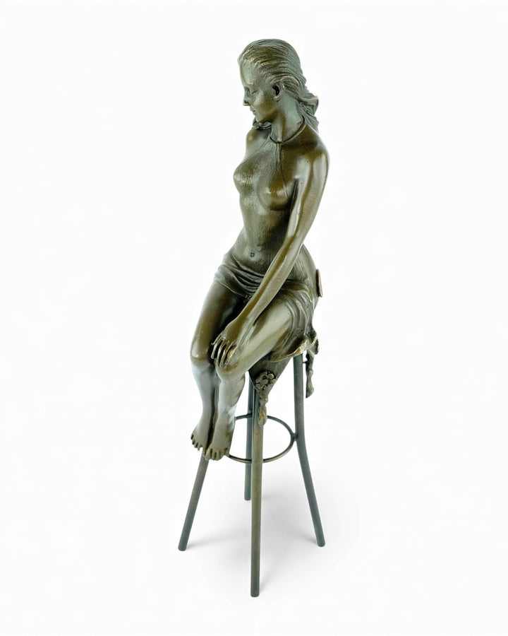 Bronze sculpture of a female on a barstool wearing a sensual dress