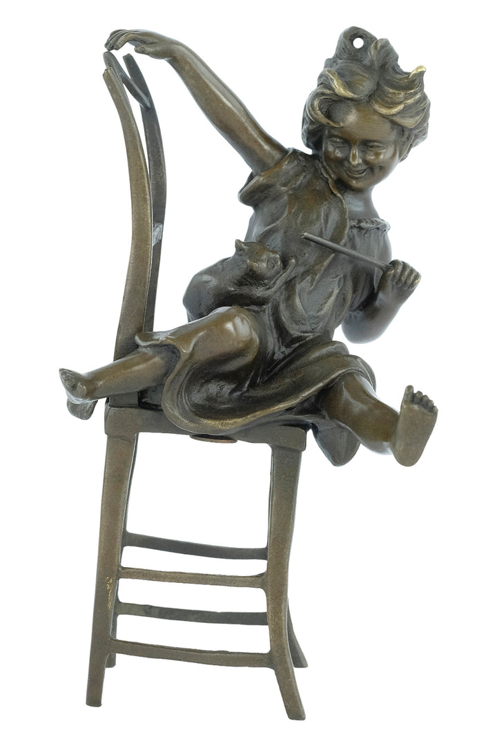 Bronze sculpture of a little girl on a chair playing with her cat
