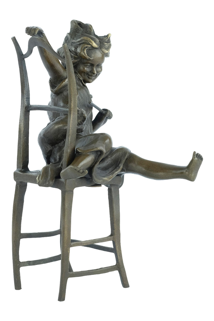 Bronze sculpture of a little girl on a chair playing with her cat