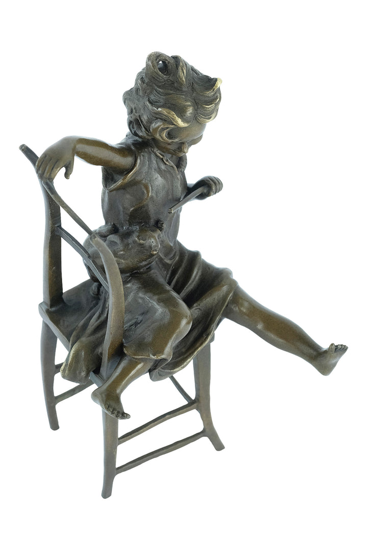 Bronze sculpture of a little girl on a chair playing with her cat
