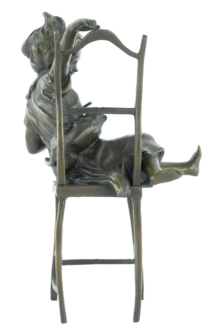 Bronze sculpture of a little girl on a chair playing with her cat