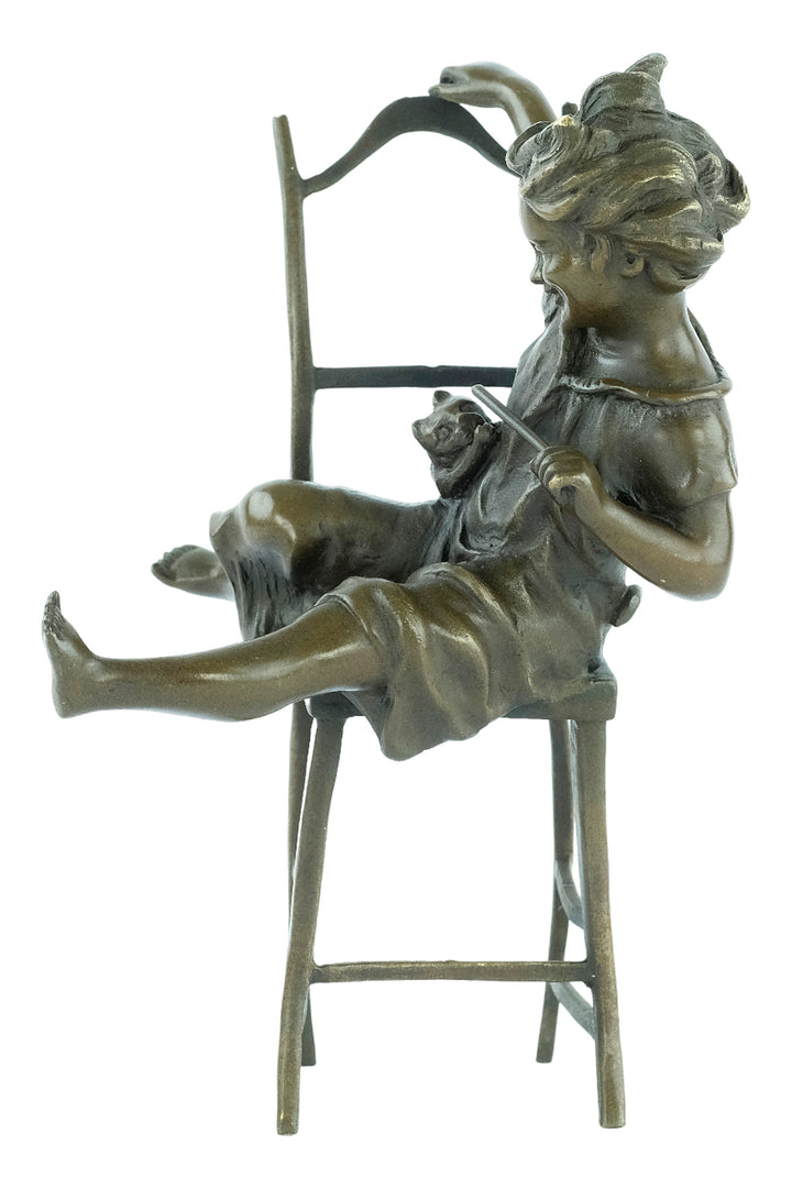 Bronze sculpture of a little girl on a chair playing with her cat