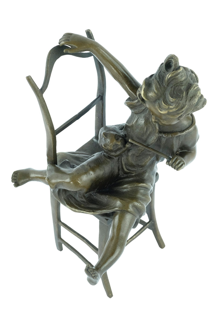 Bronze sculpture of a little girl on a chair playing with her cat