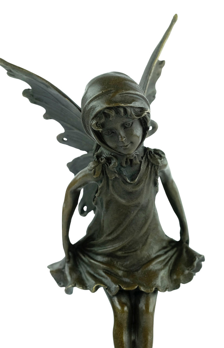 Bronze sculpture of a little winged fairy standing
