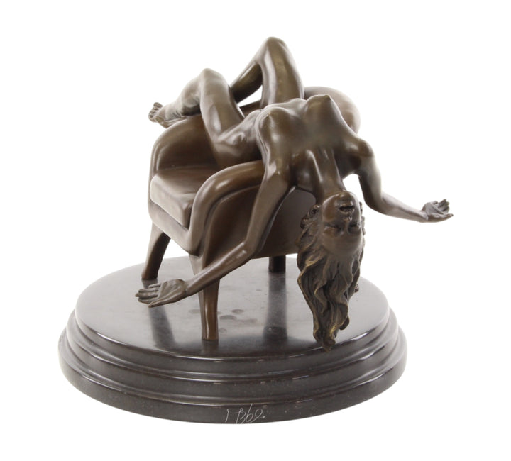 Bronze sculpture of a female nude laying on a chair