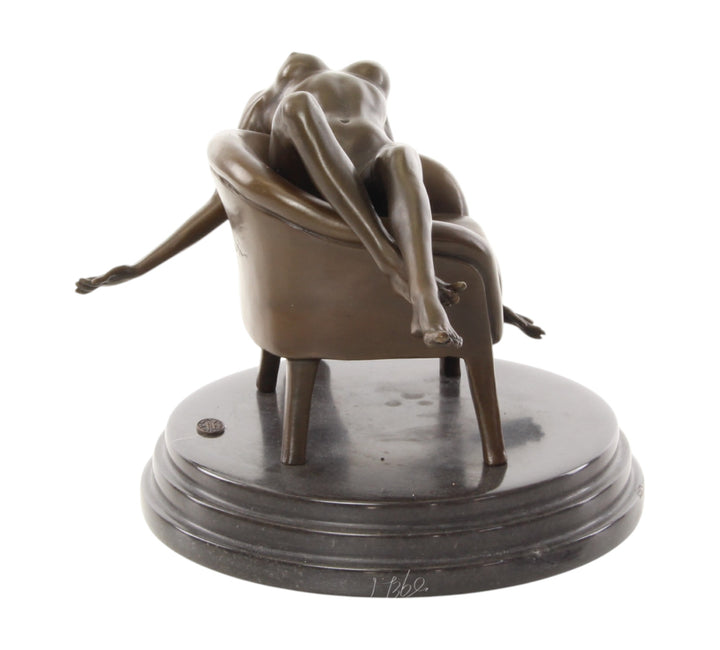 Bronze sculpture of a female nude laying on a chair