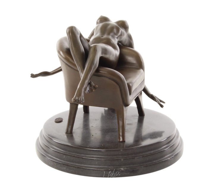 Bronze sculpture of a female nude laying on a chair