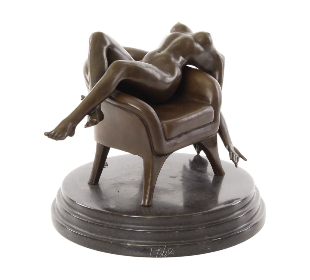 Bronze sculpture of a female nude laying on a chair
