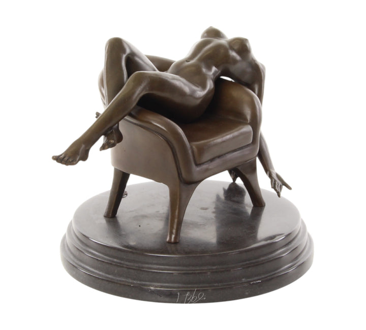 Bronze sculpture of a female nude laying on a chair
