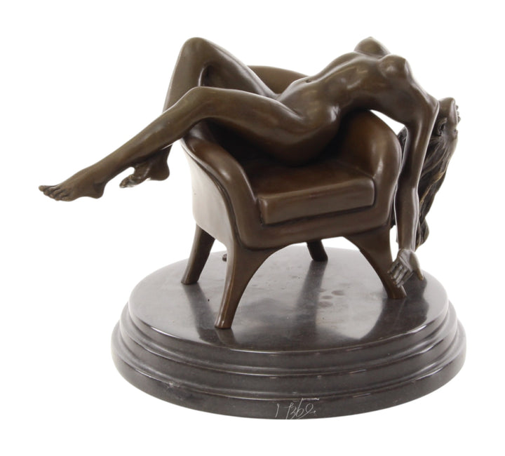 Bronze sculpture of a female nude laying on a chair