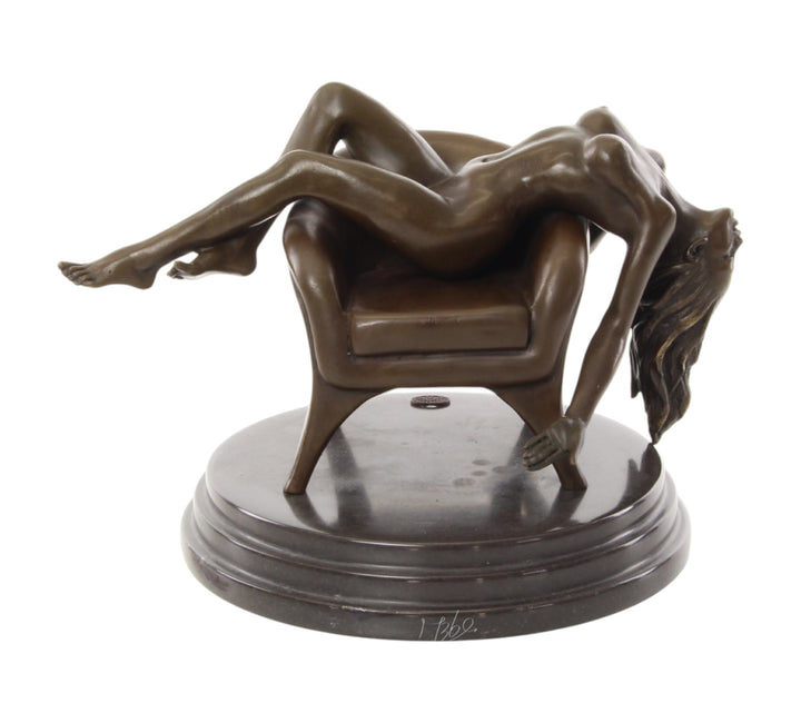 Bronze sculpture of a female nude laying on a chair