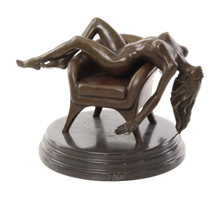 Bronze sculpture of a female nude laying on a chair