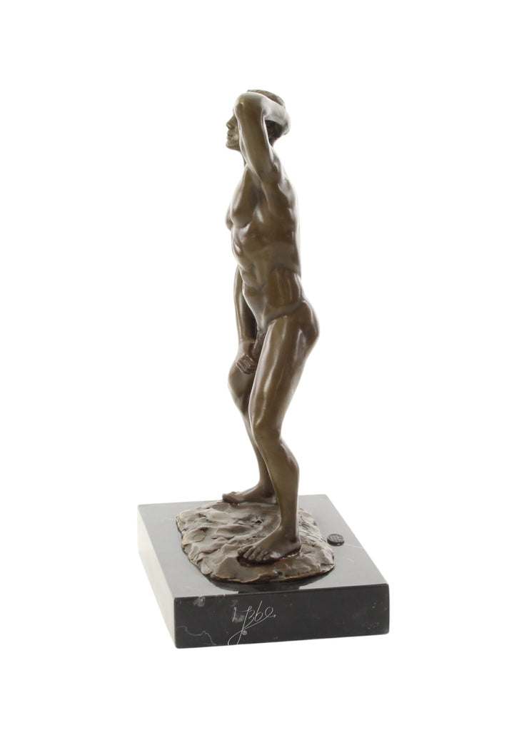 Bronze sculpture of a posing mascular male holding his phallus