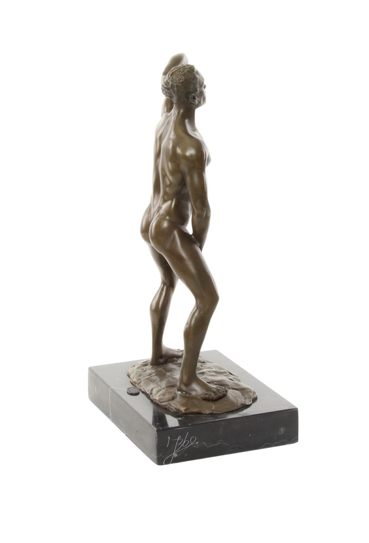 Bronze sculpture of a posing mascular male holding his phallus