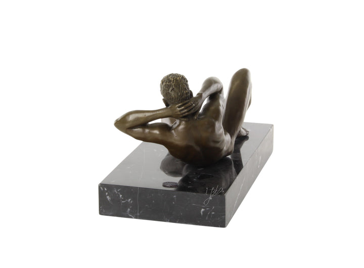 Bronze sculpture of a reclining male nude posing