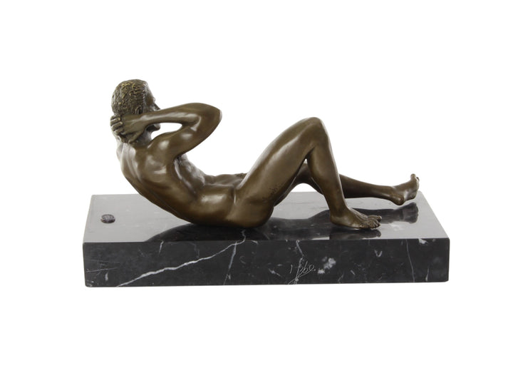Bronze sculpture of a reclining male nude posing