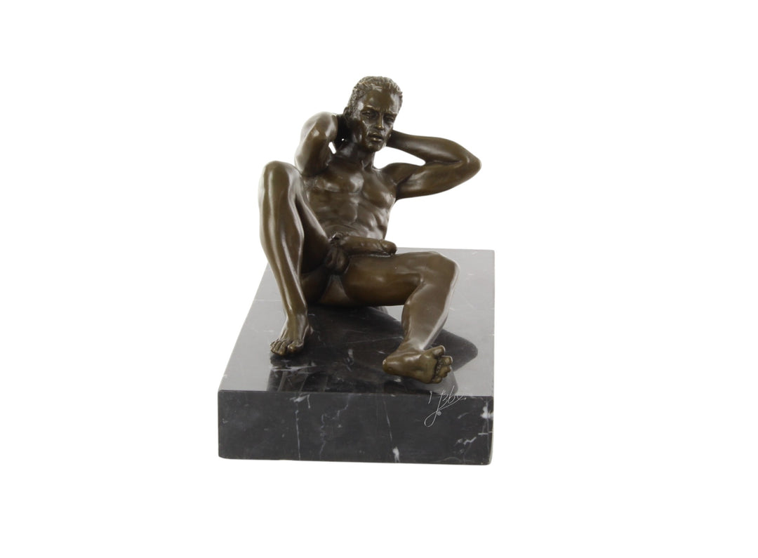 Bronze sculpture of a reclining male nude posing