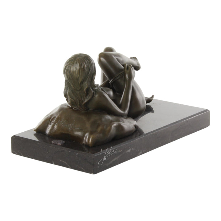 Bronze sculpture of a female nude taking off her panties