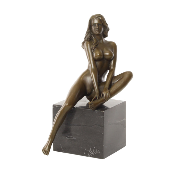 Bronze sculpture of a seated female nude with raised leg