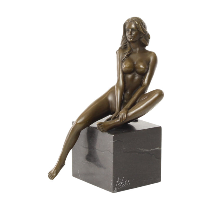 Bronze sculpture of a seated female nude with raised leg