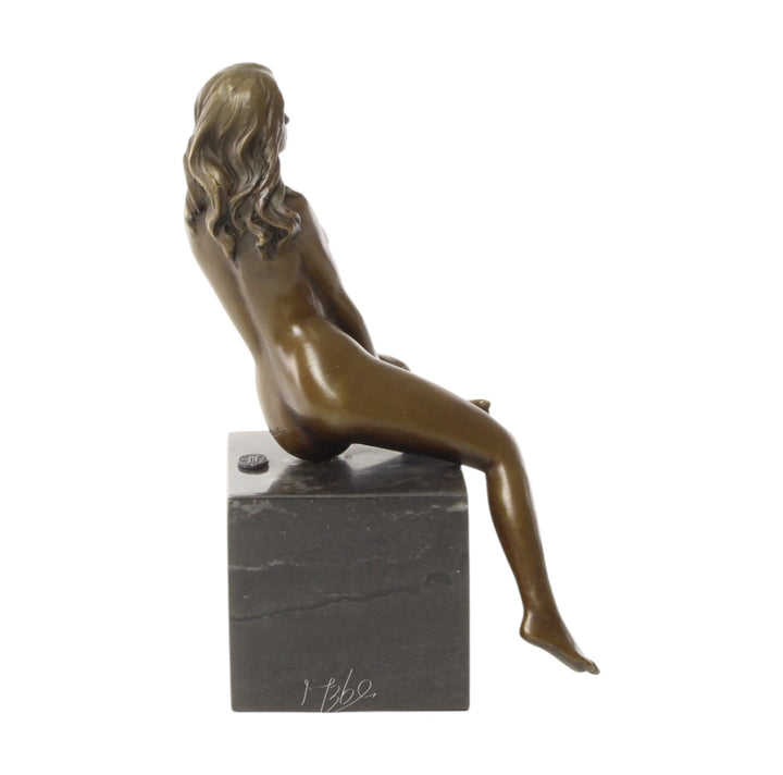 Bronze sculpture of a seated female nude with raised leg
