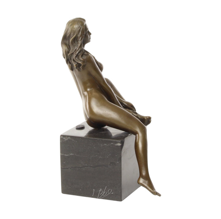 Bronze sculpture of a seated female nude with raised leg