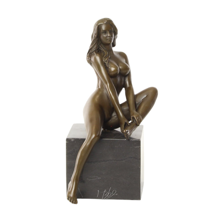 Bronze sculpture of a seated female nude with raised leg