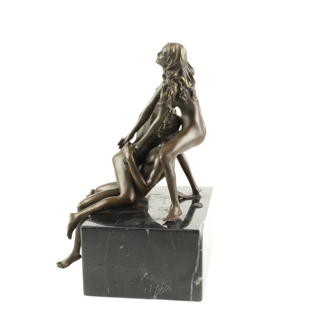 Bronze sculpture of a trio lovemaking scene