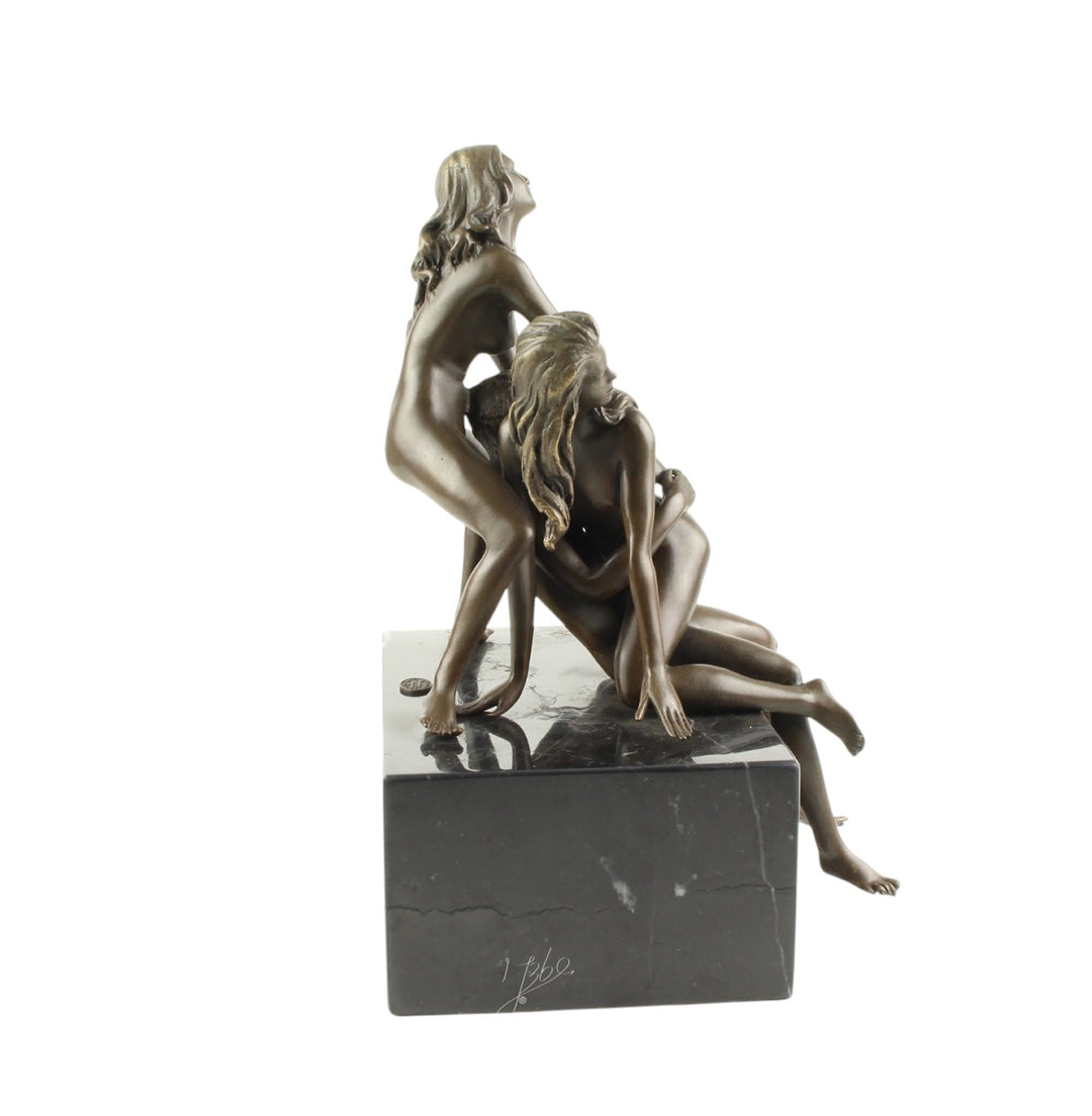 Bronze sculpture of a trio lovemaking scene