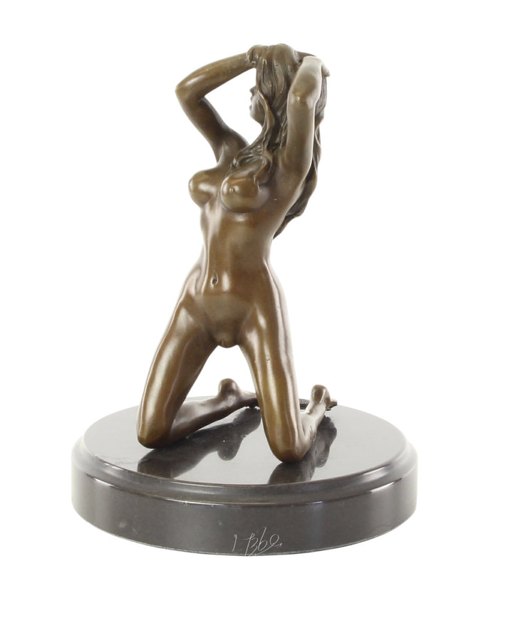 Erotic bronze sculpture of a female nude posing on her knees