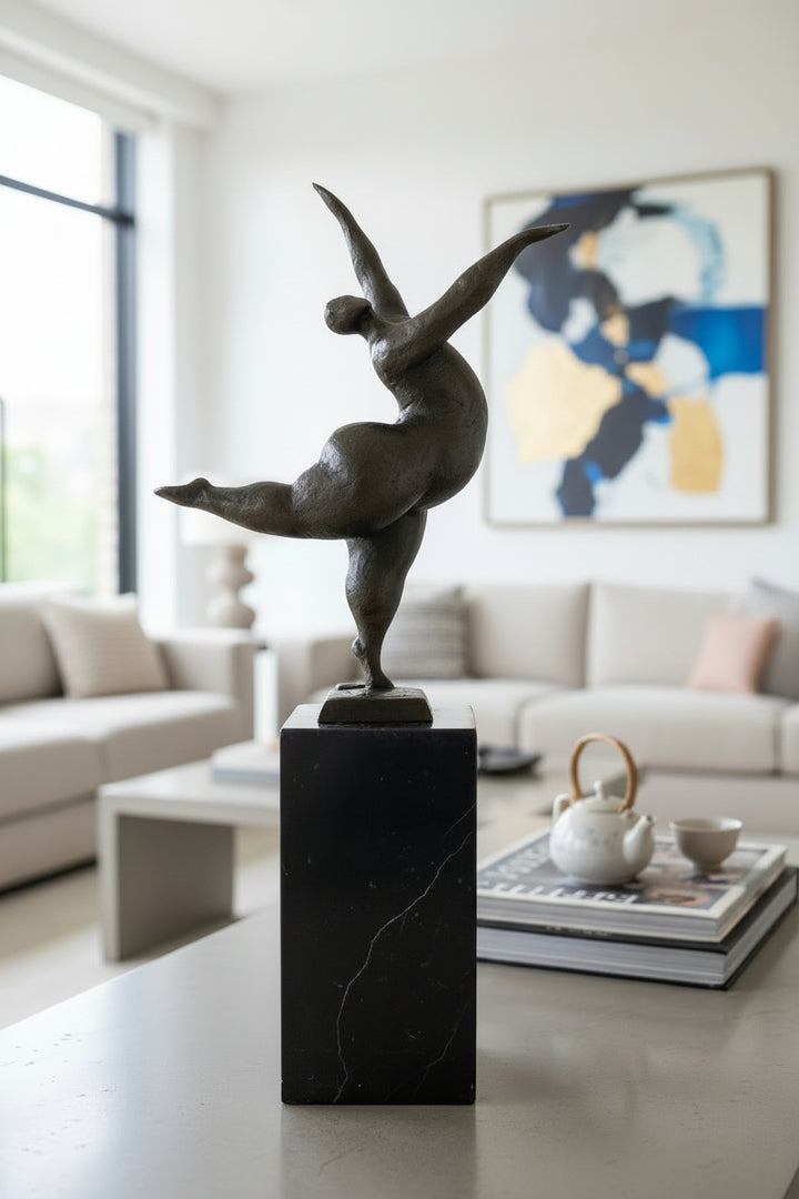 Bronze sculpture of a voluptuous female nude dancing freely