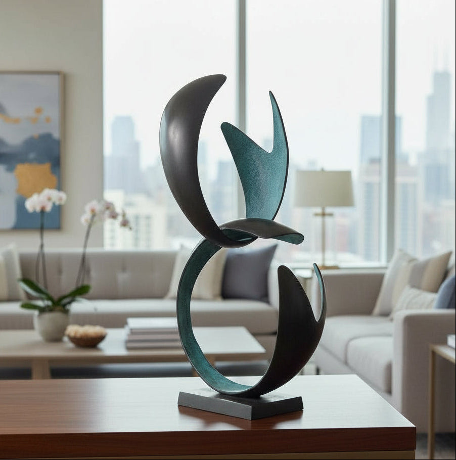 Abstract metal sculpture on a table in a modern living room with large windows.