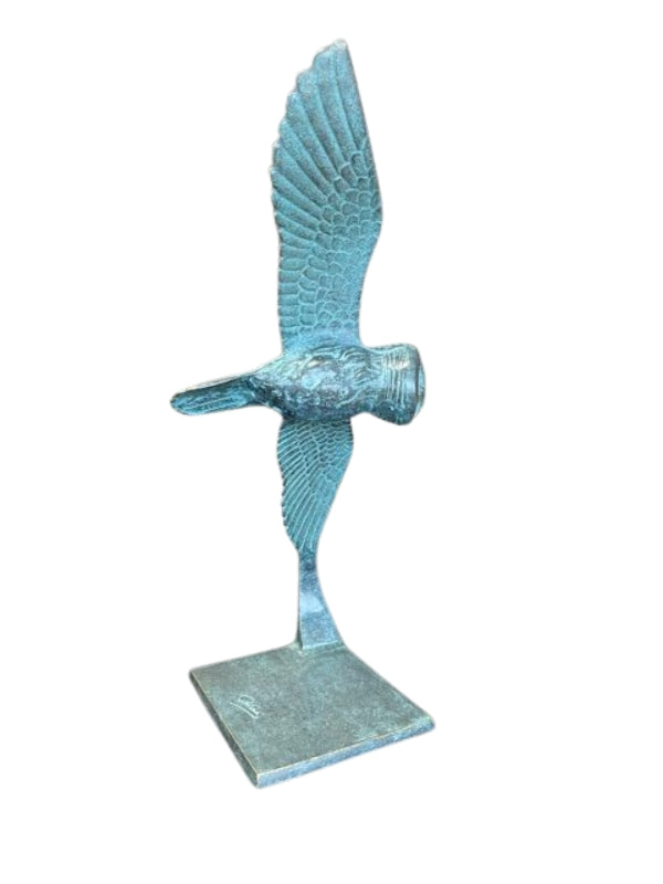 Bronze sculpture of an owl gliding through the air
