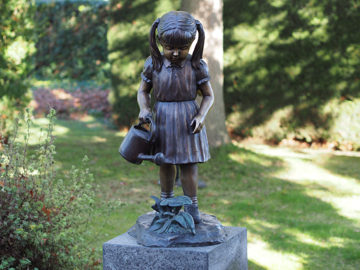 Bronze sculpture of a little girl watering the plants