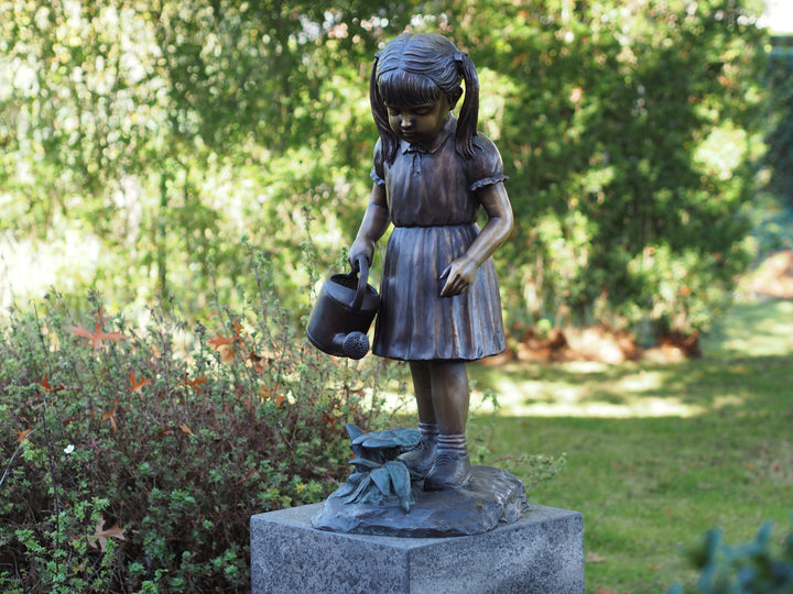 Bronze sculpture of a little girl watering the plants