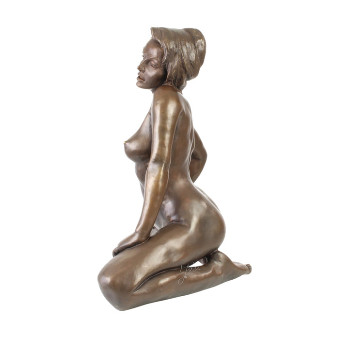 Large bronze sculpture of a kneeling female nude